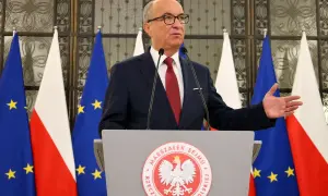 Marszałek Sejmu przemawia na tle flag Polski i UE, gestykulując. Mowa dotyczy odrzucenia weta prezydenta.