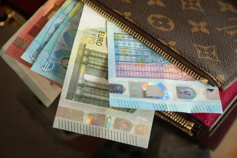 Euro banknoty w portfelu z monogramem.