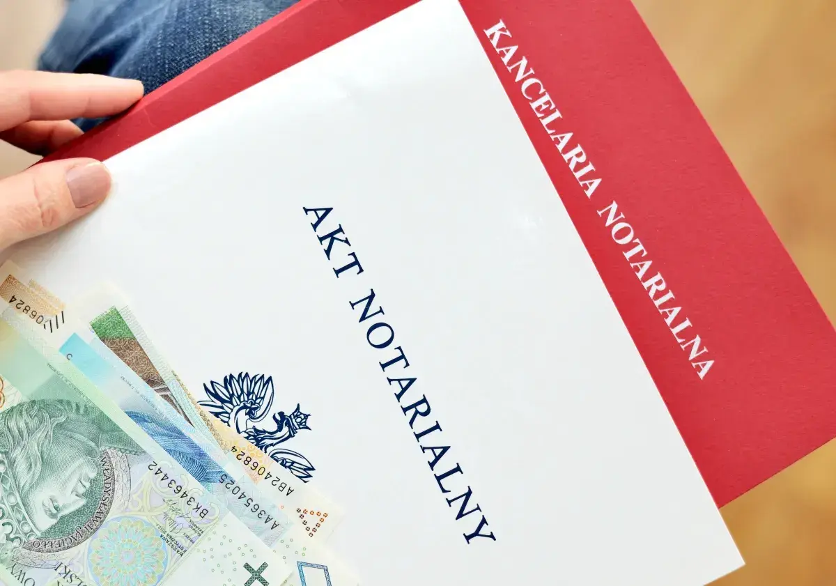 Akt notarialny i polskie banknoty. Kancelaria notarialna przygotowuje dokumenty, a pieniądze czekają na depozyt.